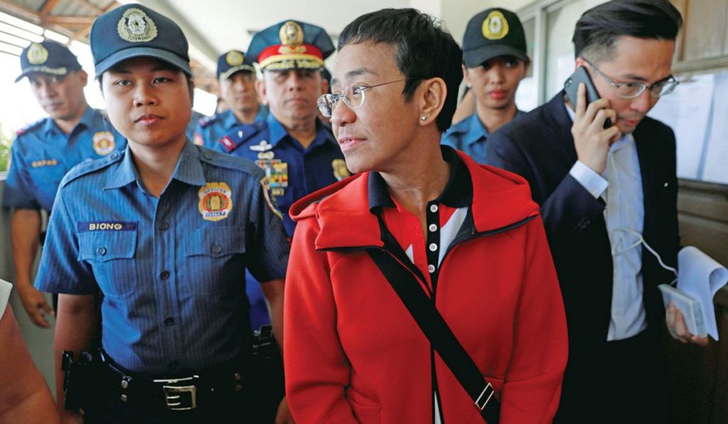 Photo of Maria Ressa being arrested