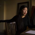 May Jeong sitting at a table.