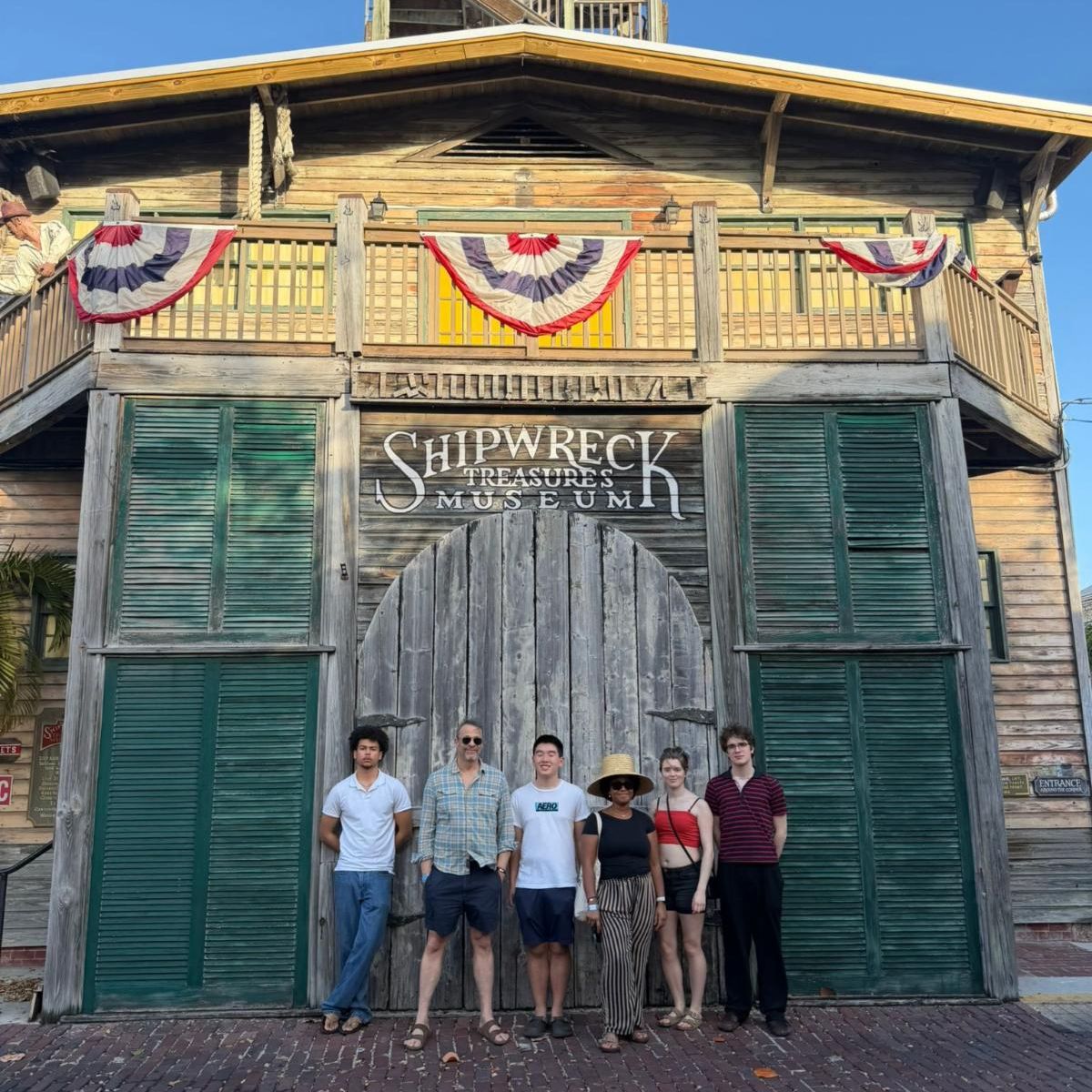 Journalism students in front of Shipwreck Treasures Museum